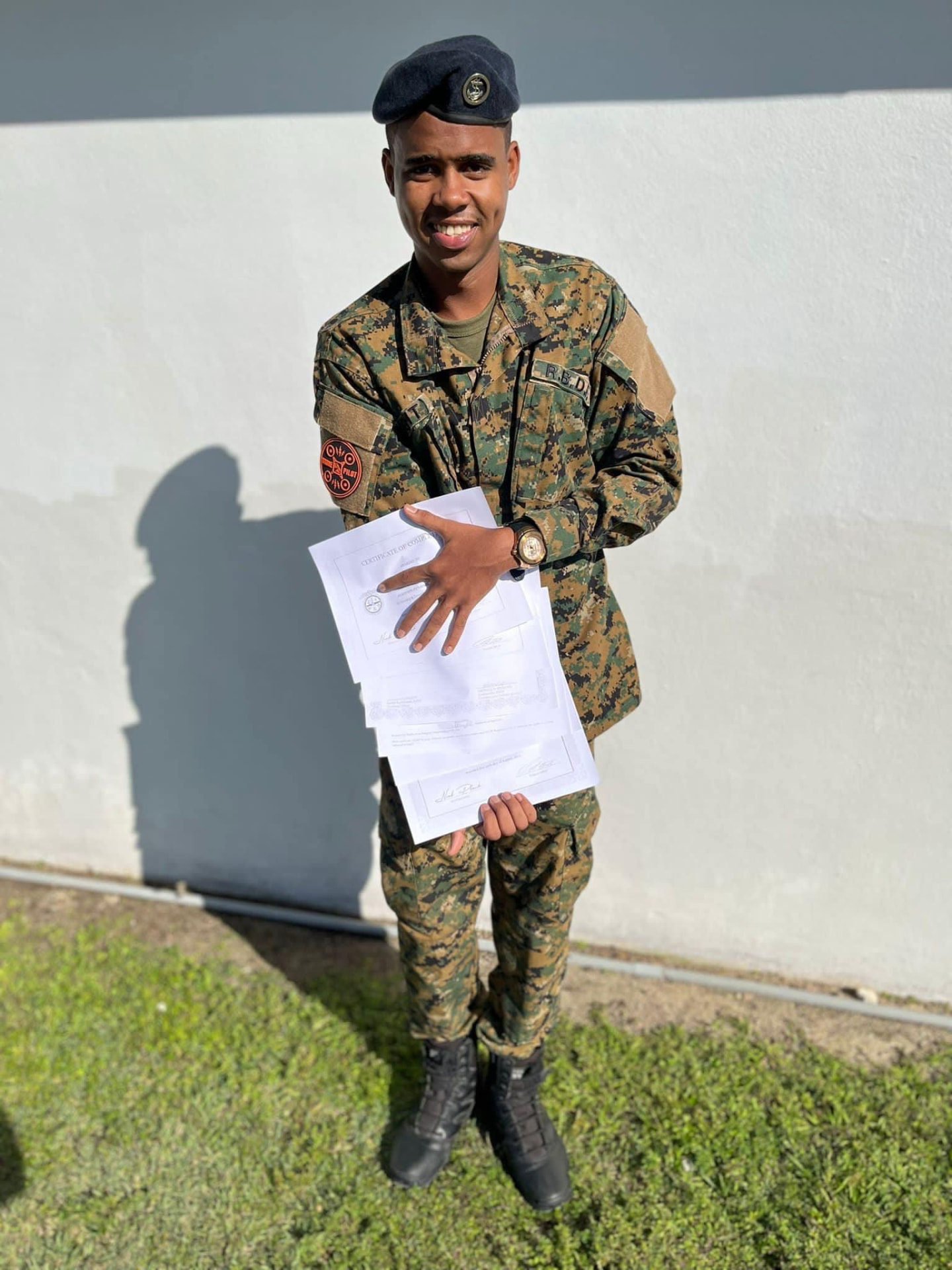 Andrick Wright in camouflage uniform holding documents