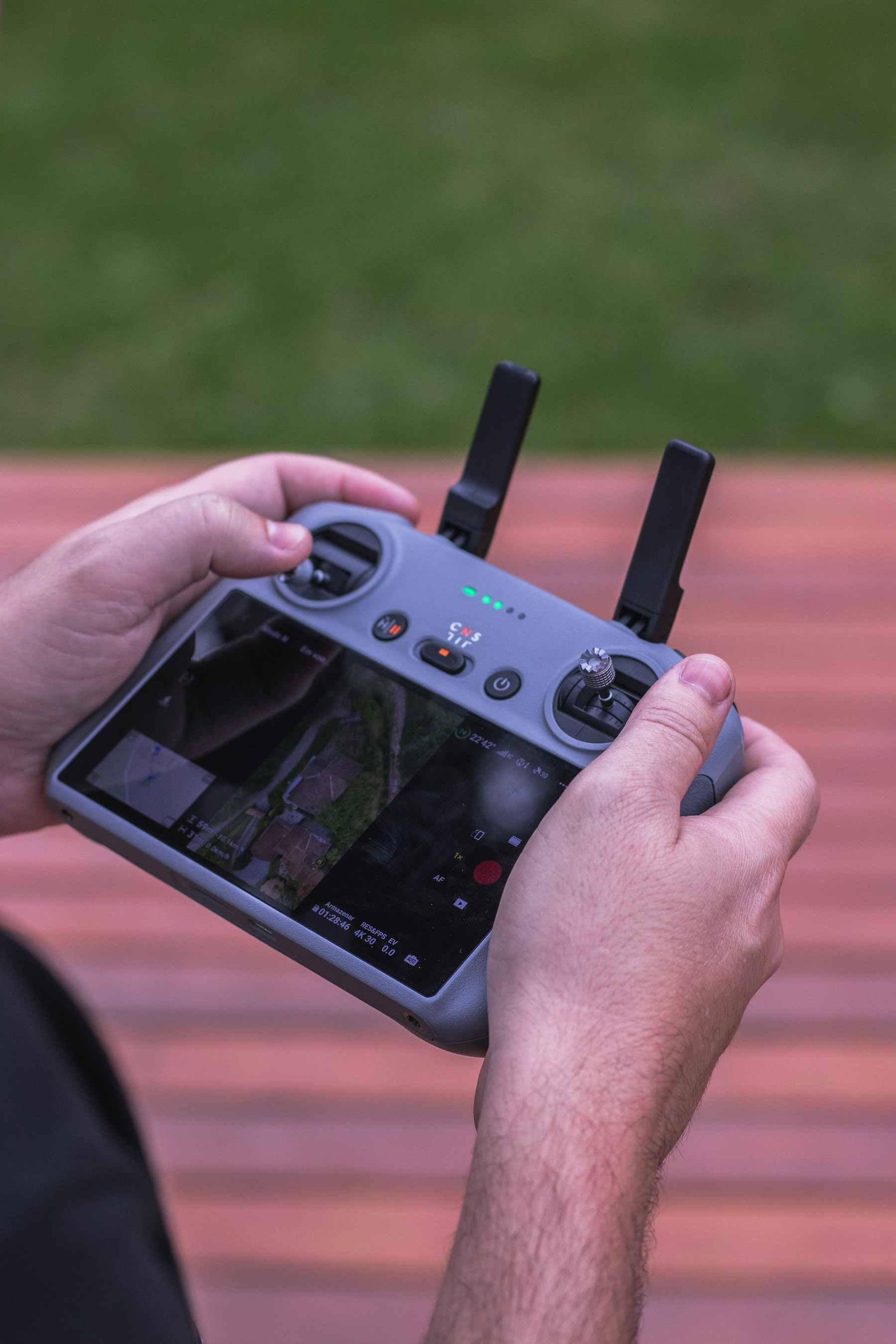 Hands operating a drone remote controller outdoors — stock photograph