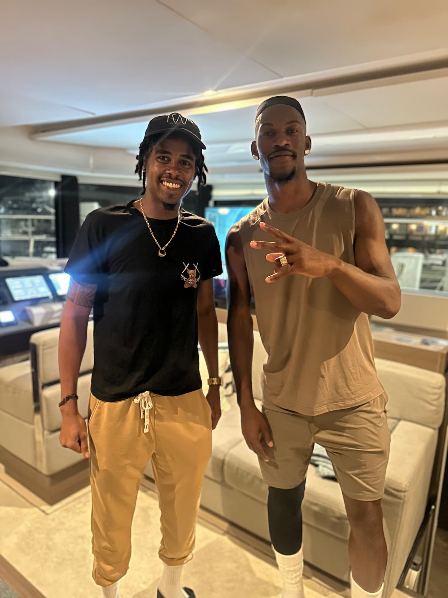 Two people standing inside a yacht cabin