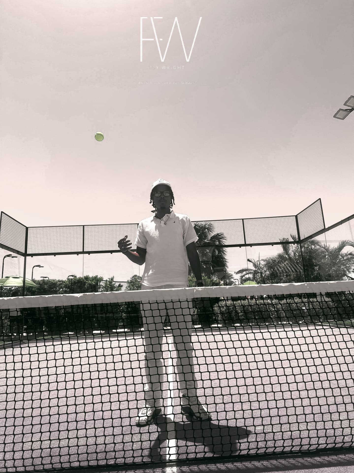 Black-and-white photograph of a tennis player behind the net